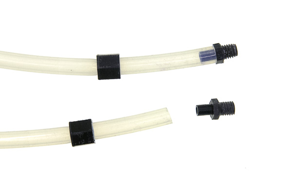 two sleeves on two hoses, with two adapters: one lying near, another already put on